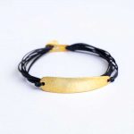 Bracelet with silver gold plated elements and strings